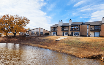 A row of houses with a body of water in front.